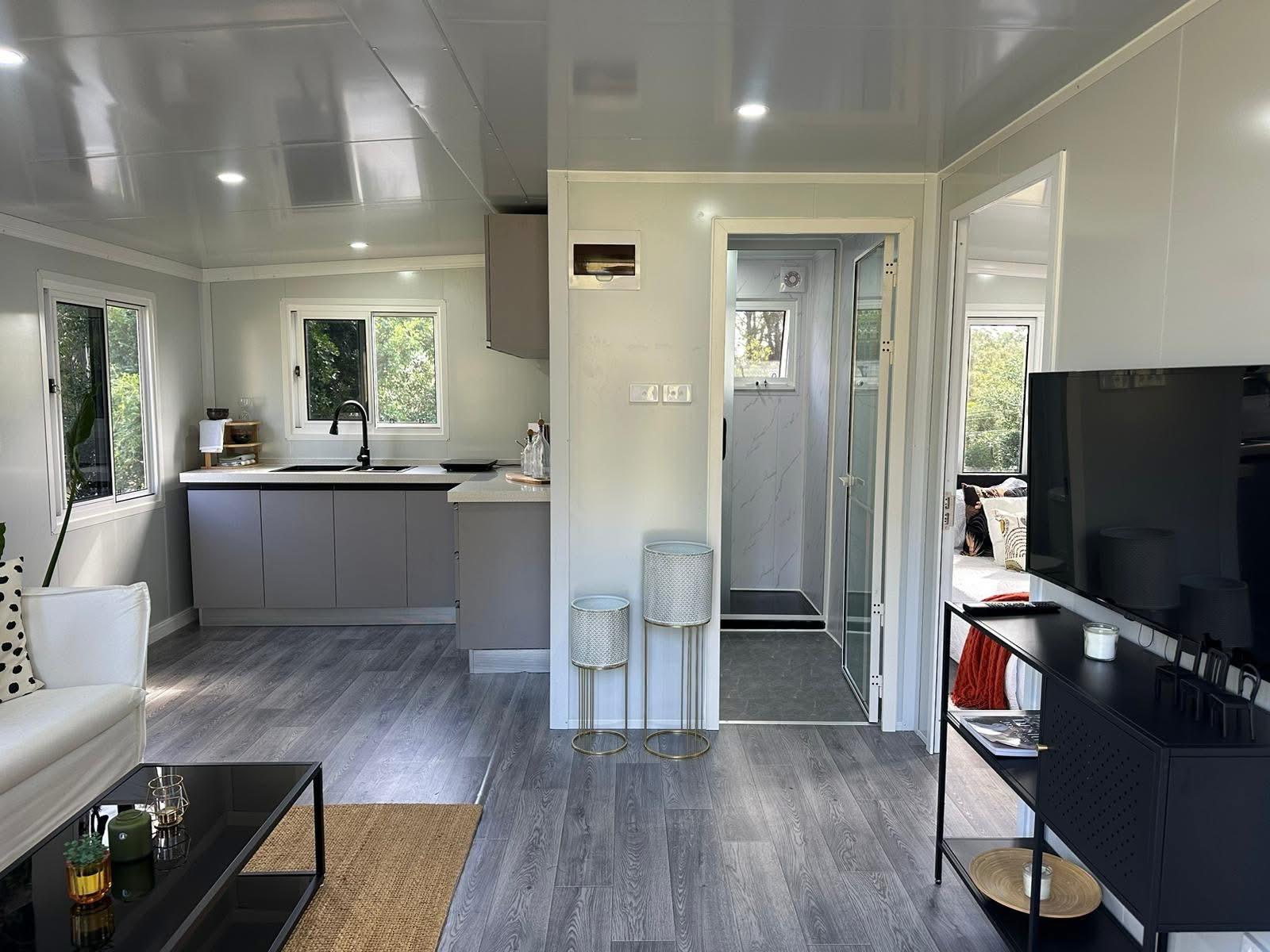 Finished living room and kitchen interior with real furnishings and natural light